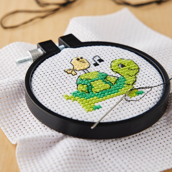 green turtle cross stitch project with needle